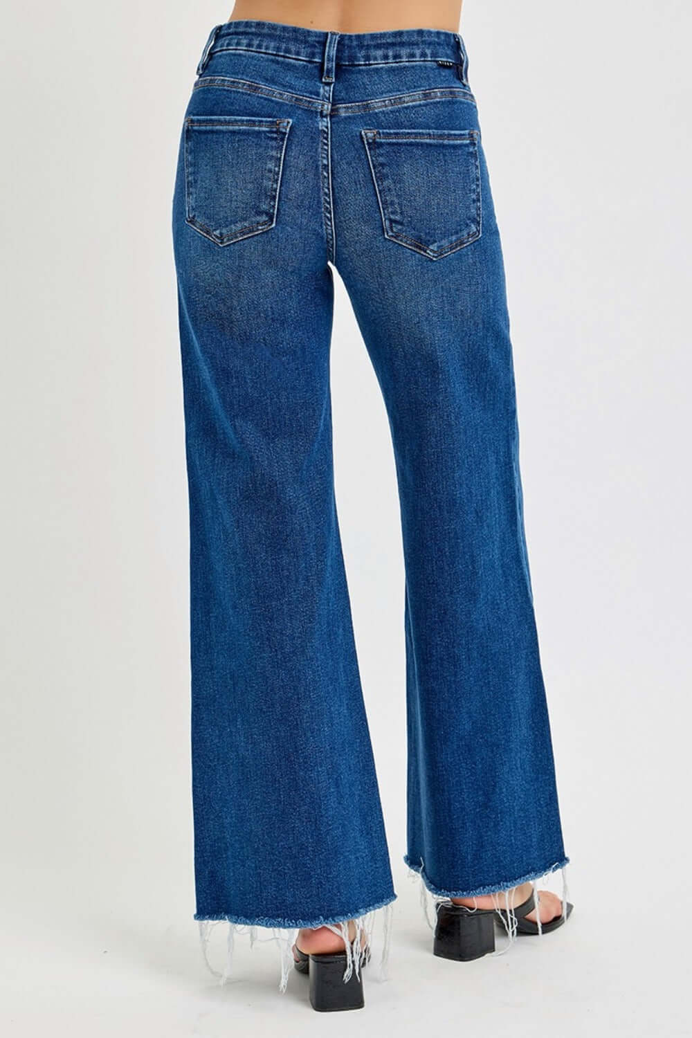 High rise wide leg jeans with pockets and frayed hem, featuring a trendy and chic style for a fashion-forward look