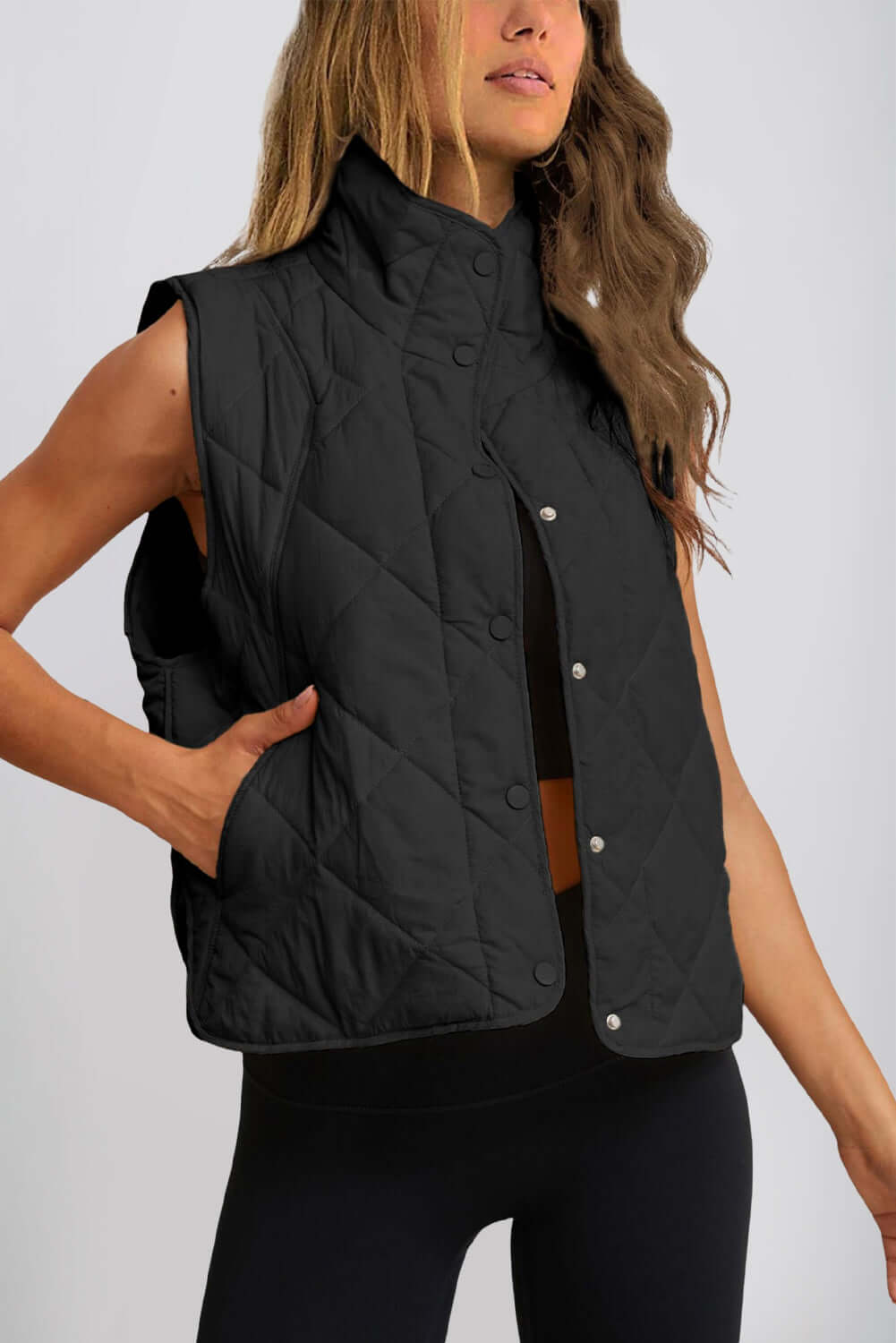 Bella Road Snap Down Vest Coat in black, featuring textured design and pockets, perfect for staying warm and stylish in fall or winter.