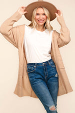 Cozy stripe textured open front cardigan with pockets, perfect for layering and adding style, worn over casual outfit.