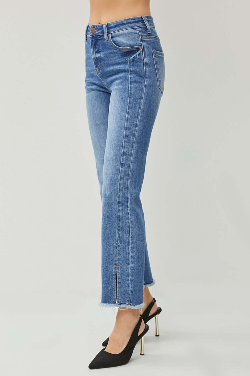 High Waist Raw Hem Slit Straight Risen Jeans styled with black heels for a trendy look.