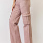 Woman wearing RISEN Full Size High Rise Cargo Wide Leg Jeans in pink, showcasing the high-rise fit and functional cargo pockets.