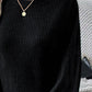 Woman wearing Bella Road Ribbed Round Neck Lantern Sleeve T-Shirt in black, showing ribbed texture and lantern sleeves.