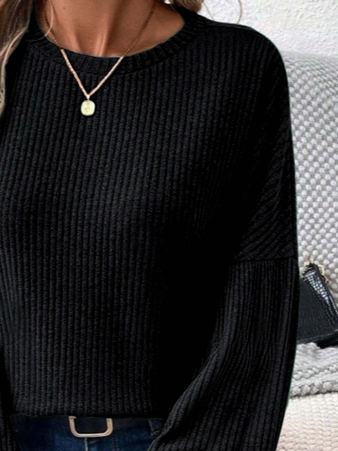 Woman wearing Bella Road Ribbed Round Neck Lantern Sleeve T-Shirt in black, showing ribbed texture and lantern sleeves.