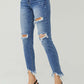 Distressed Frayed Hem Slim Risen Jeans on model, showcasing trendy ripped details and flattering slim fit for edgy fashion.