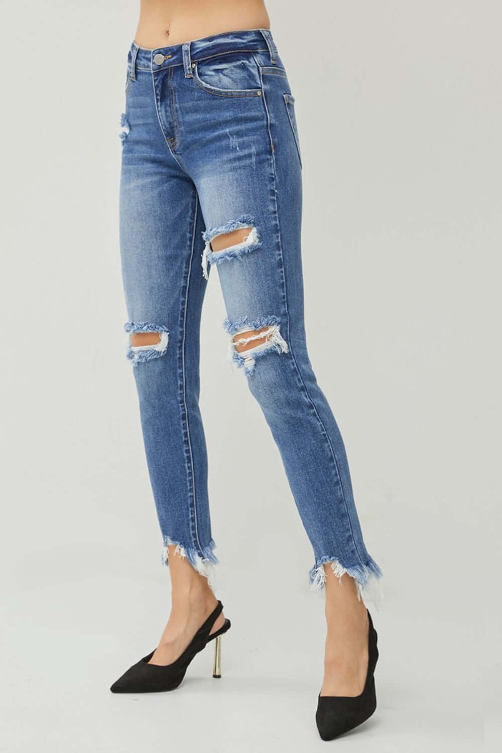 Distressed Frayed Hem Slim Risen Jeans on model, showcasing trendy ripped details and flattering slim fit for edgy fashion.