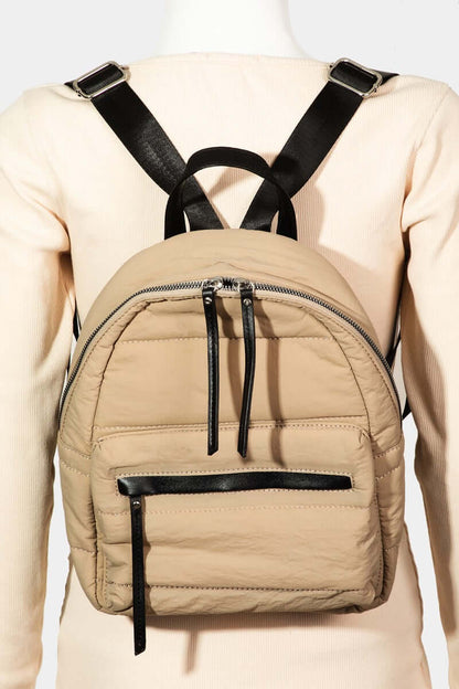 Stylish beige nylon backpack with adjustable straps, ideal for travel and everyday use, showcasing multiple compartments.