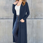 Woman wearing open front long sleeve cover up with pockets in navy blue over casual white top and jeans