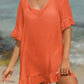 Woman wearing orange tied ruffled half sleeve cover-up on the beach, sheer fabric with no stretch, 65% cotton, 35% polyester.