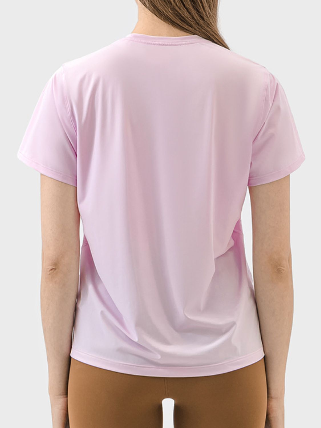 Back view of Millennia Slit Round Neck Short Sleeve Active T-Shirt in blush pink, showcasing its sleek design and breathable fabric.