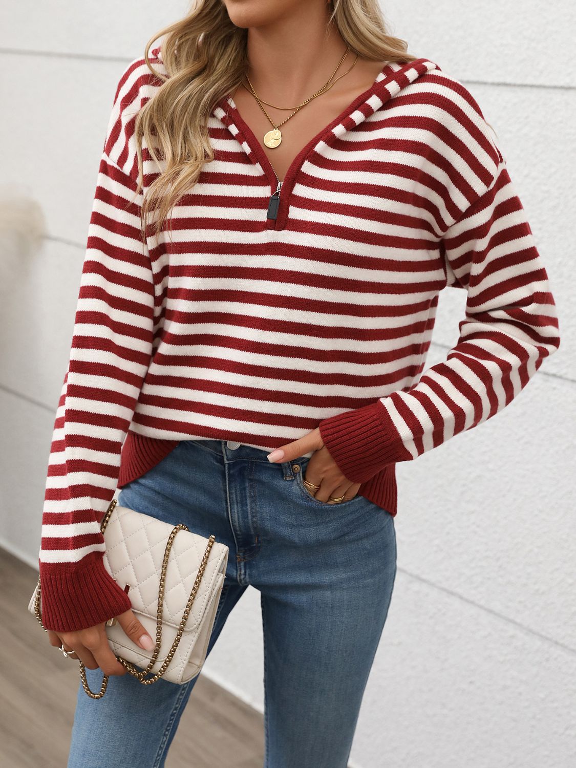 Woman wearing Perfee Striped Long Sleeve Hooded Sweater in burgundy, paired with jeans and a crossbody bag.