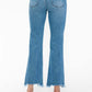 Back view of bytos Raw Hem Distressed Mid Rise Crop Jeans with flared legs and raw hems, showcasing a trendy denim look.