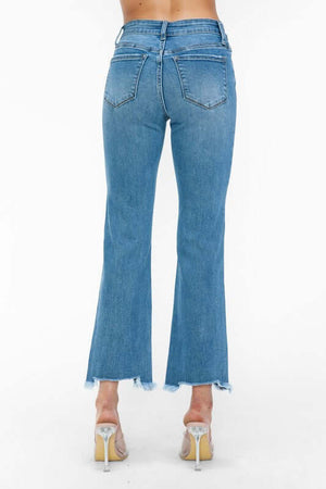 Back view of bytos Raw Hem Distressed Mid Rise Crop Jeans with flared legs and raw hems, showcasing a trendy denim look.