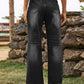 Black distressed jeans with stylish pockets, high waist, and relaxed fit, perfect for an edgy look.