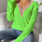 Bright green v-neck sweater with openwork design and long sleeves, perfect for a stylish and cozy look.