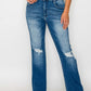 Model showcasing bytos Full Size Raw Hem Distressed High Rise Bootcut Jeans with a trendy lived-in look.