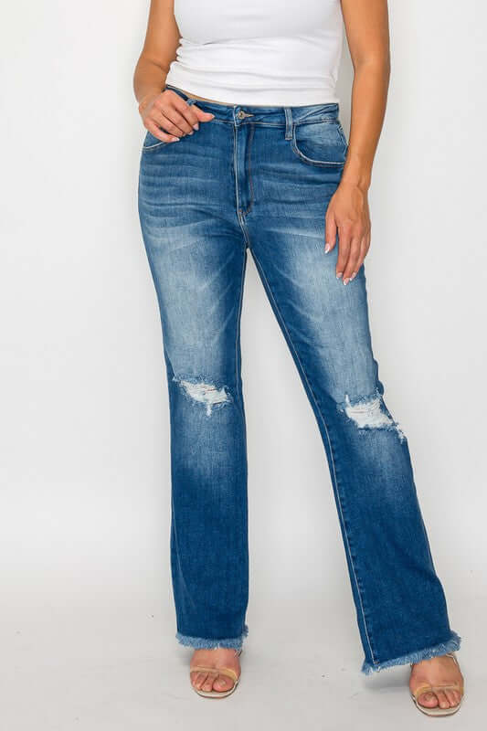 Model showcasing bytos Full Size Raw Hem Distressed High Rise Bootcut Jeans with a trendy lived-in look.