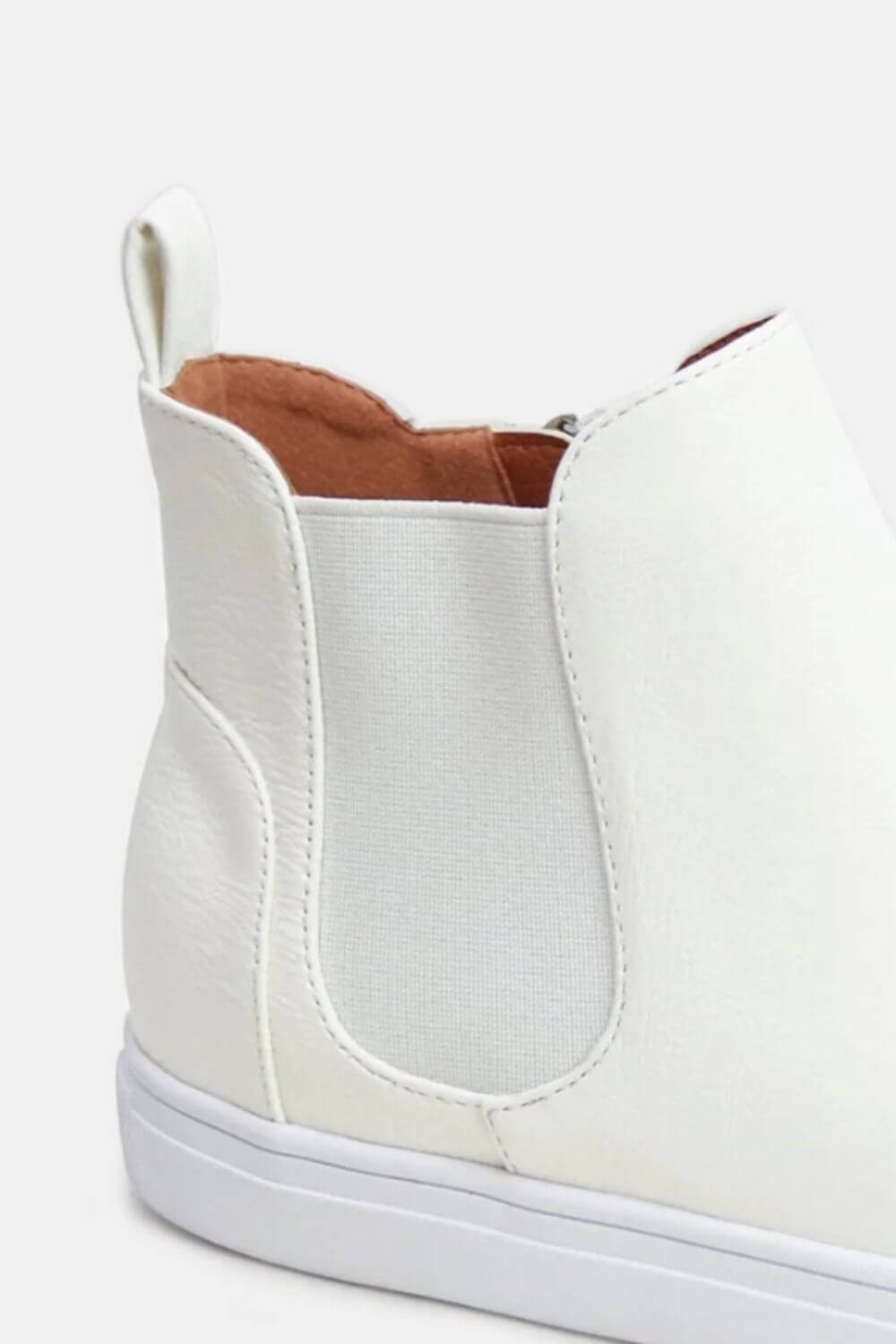 Trendy white faux suede sneakers with elastic side panels for a stylish and comfortable fit. Perfect for everyday wear.