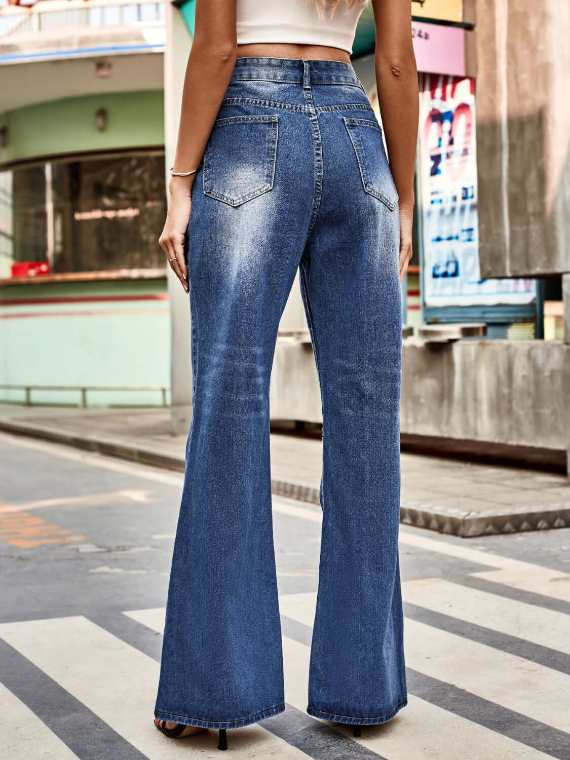 Woman wearing Bella Road High Rise Bootcut Jeans with Pockets, styled for a casual day out, featuring a trendy bootcut silhouette.