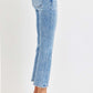 Woman wearing RISEN full size low rise crop slim straight jeans with raw hem and black heels.