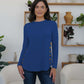 Woman wearing FAM-FAM Round Neck Long Sleeve T-Shirt in blue with decorative buttons, stylish and casual.