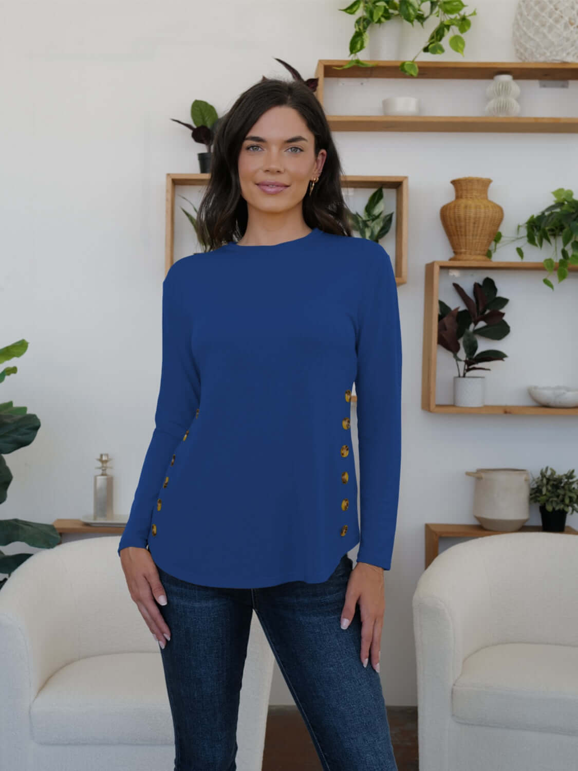 Woman wearing FAM-FAM Round Neck Long Sleeve T-Shirt in blue with decorative buttons, stylish and casual.