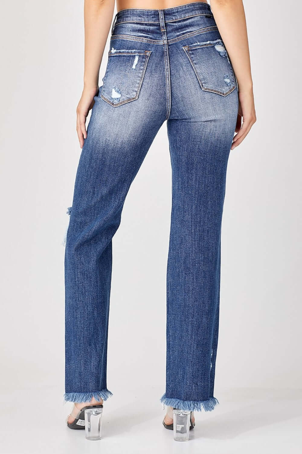 Back view of Risen Jeans raw hem distressed straight jeans with edgy raw hem and worn-in look for urban chic style.