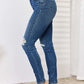 Mid Waist Distressed Slim Jeans by Judy Blue Jeans in full size, featuring a stylish mid-rise and distressed detailing for a trendy look.