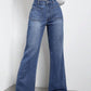 High waist bootcut jeans with pockets in blue denim, front view.