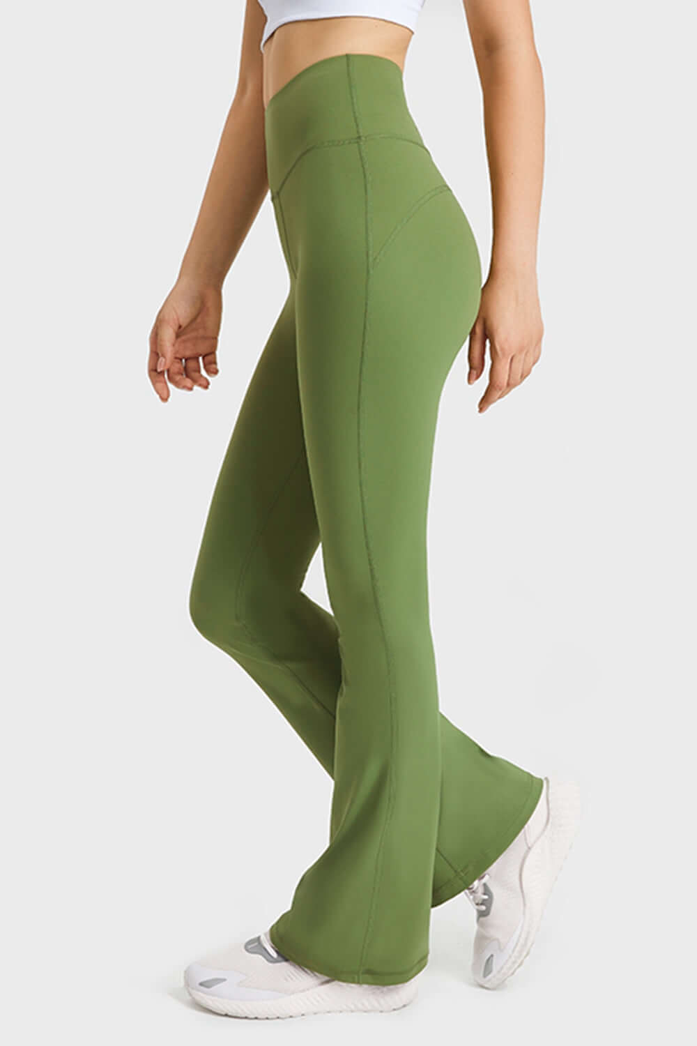 Side view of Millennia Elastic Waist Flare Yoga Pants in green, showcasing a sleek fit and comfortable design. Perfect for yoga!