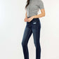 Woman wearing Cat's Whiskers Raw Hem High Waist Jeans with a casual grey top and black mules, showcasing trendy vintage-inspired style.