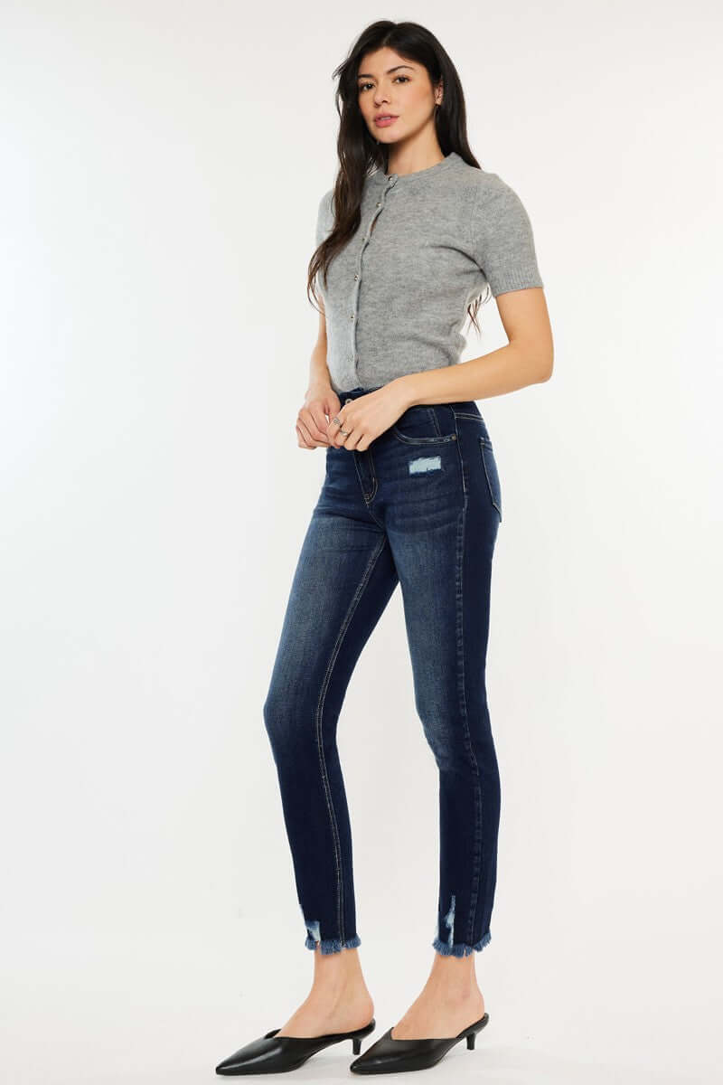 Woman wearing Cat's Whiskers Raw Hem High Waist Jeans with a casual grey top and black mules, showcasing trendy vintage-inspired style.