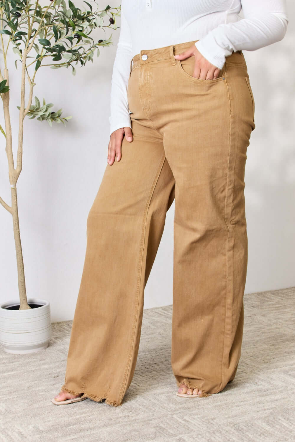 Wide-leg fringe hem Risen Jeans in tan, featuring a high-waisted fit and slightly stretchy material for a flattering, versatile look.