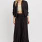 Model wearing RISEN Shirring Detail Wide Leg Pants paired with a black shirt for a chic and elegant look.