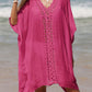 Woman wearing a pink cutout V-neck three-quarter sleeve cover up, made of sheer fabric with openwork design, standing on a beach.