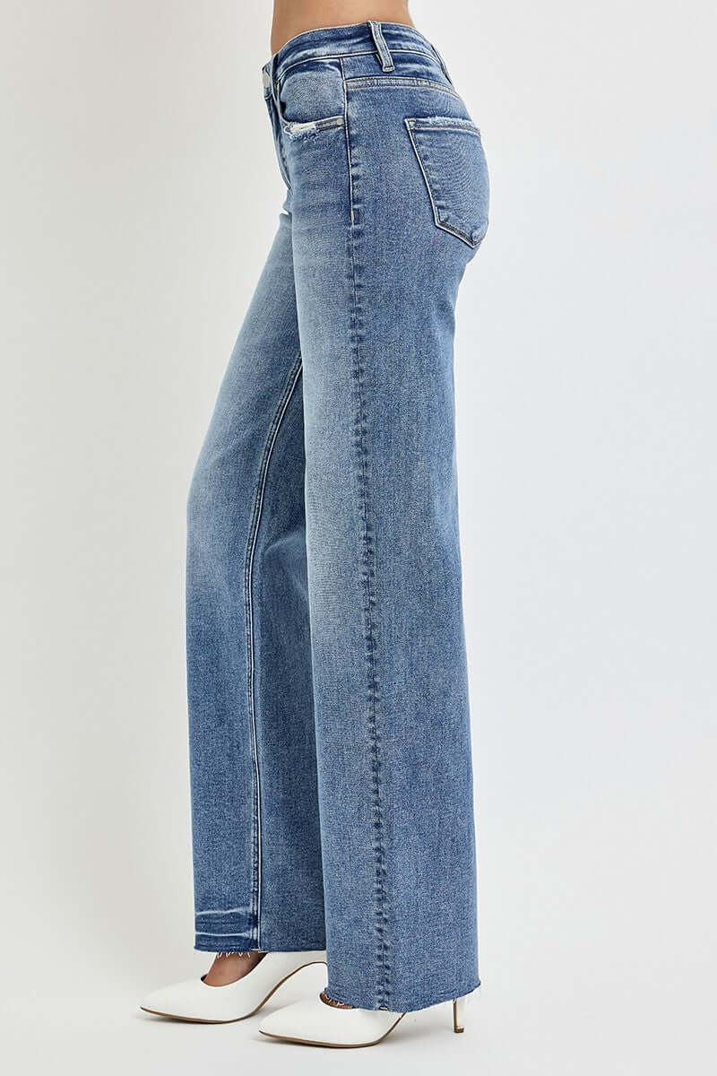 Risen high rise straight leg jeans with pockets, showcasing a flattering waistline and casual, stylish look. Perfect for everyday fashion.