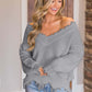 Woman wearing Bella Road Frayed Hem Dropped Shoulder Sweater in stylish gray, looking chic and cozy in a casual setting.