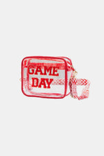 Transparent crossbody bag with red "GAME DAY" letters, glitter trim, and patterned strap. Stadium approved and stylish for any event.