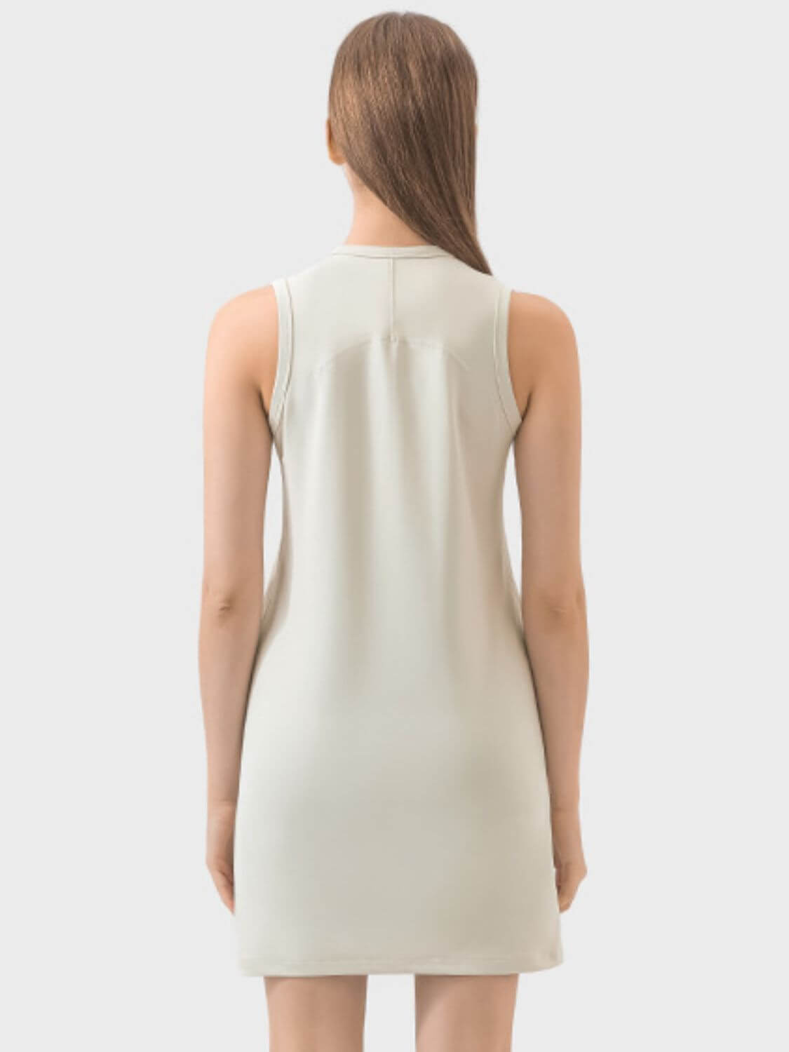 Back view of the Millennia Round Neck Sleeveless Active Dress in a light color, showcasing its comfortable and stylish design.