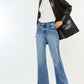 Woman wearing Kancan High Rise Wide Leg Jeans and stylish blazer, showcasing chic comfort and style in a modern outfit.