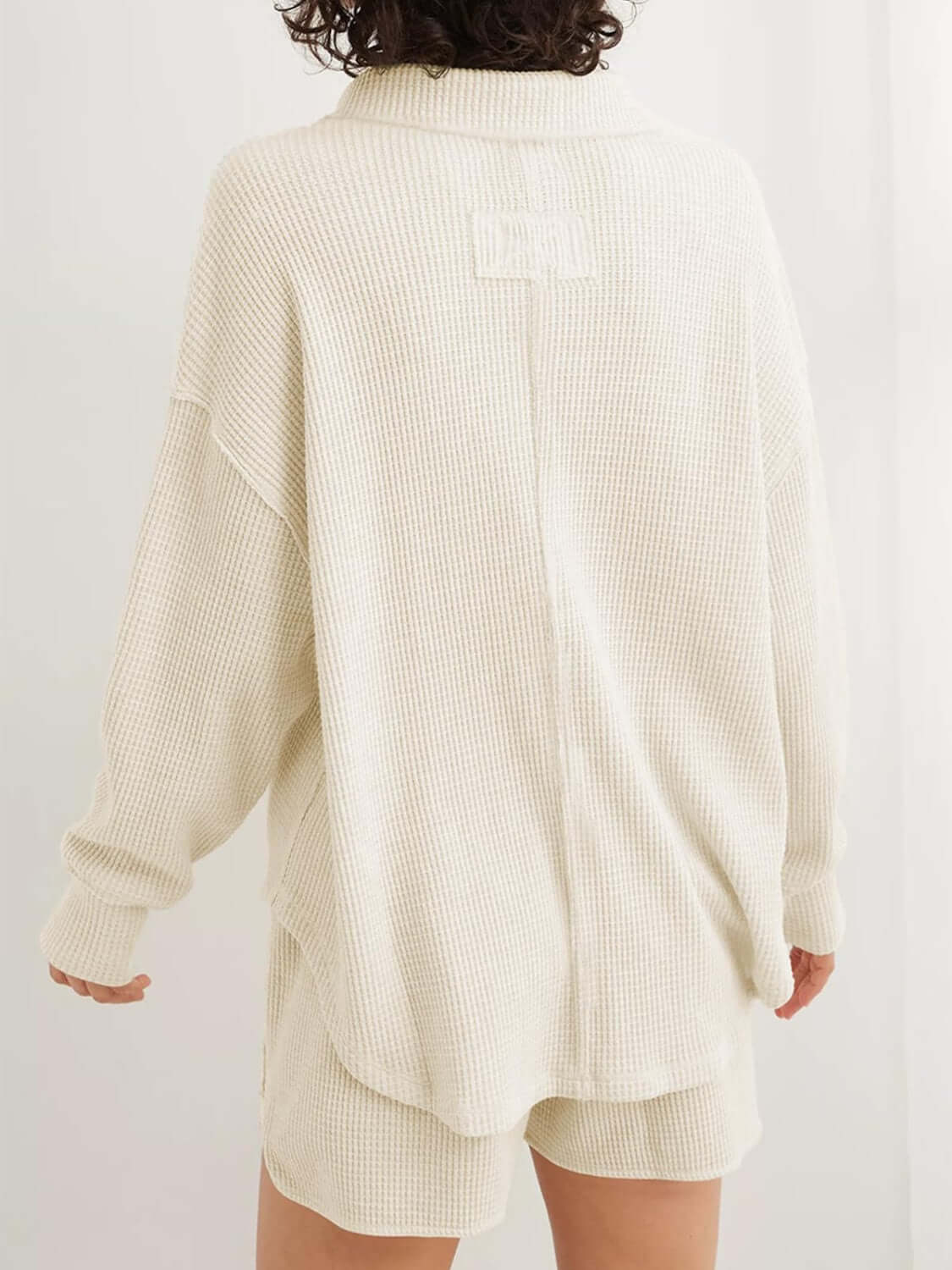 Back view of waffle-knit Johnny collar long sleeve sweatshirt in off-white color paired with matching shorts.