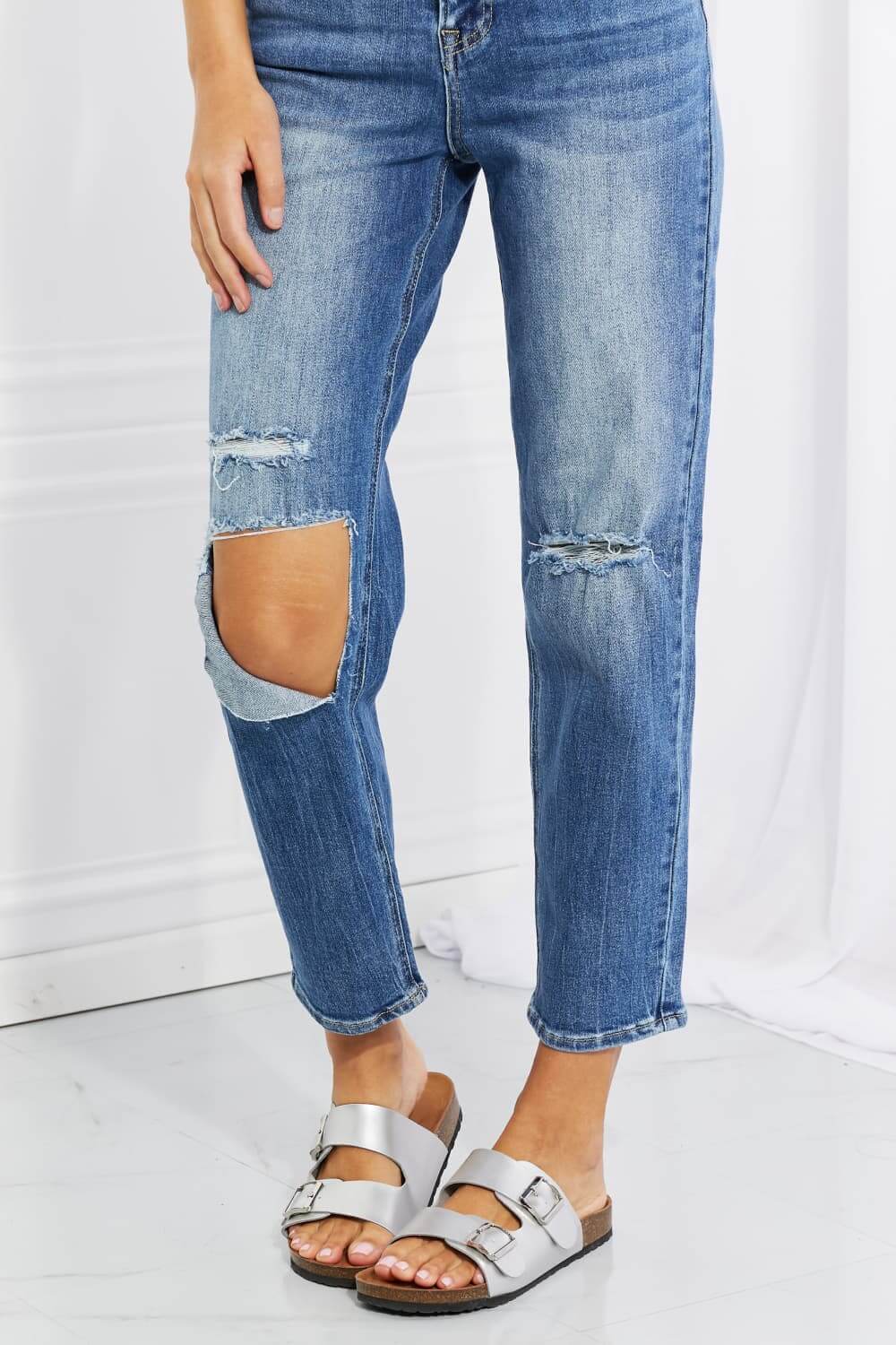 Emily High Rise Relaxed Jeans with ripped knees, showing moderate stretch in a cropped length. Perfect casual style by Risen Jeans.