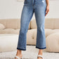 Woman wearing Judy Blue release hem cropped bootcut jeans with white heels showcasing trendy and versatile denim style.