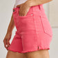 Woman wearing pink tummy control high waist raw hem denim shorts by RFM Jeans for a stylish and comfortable fit.