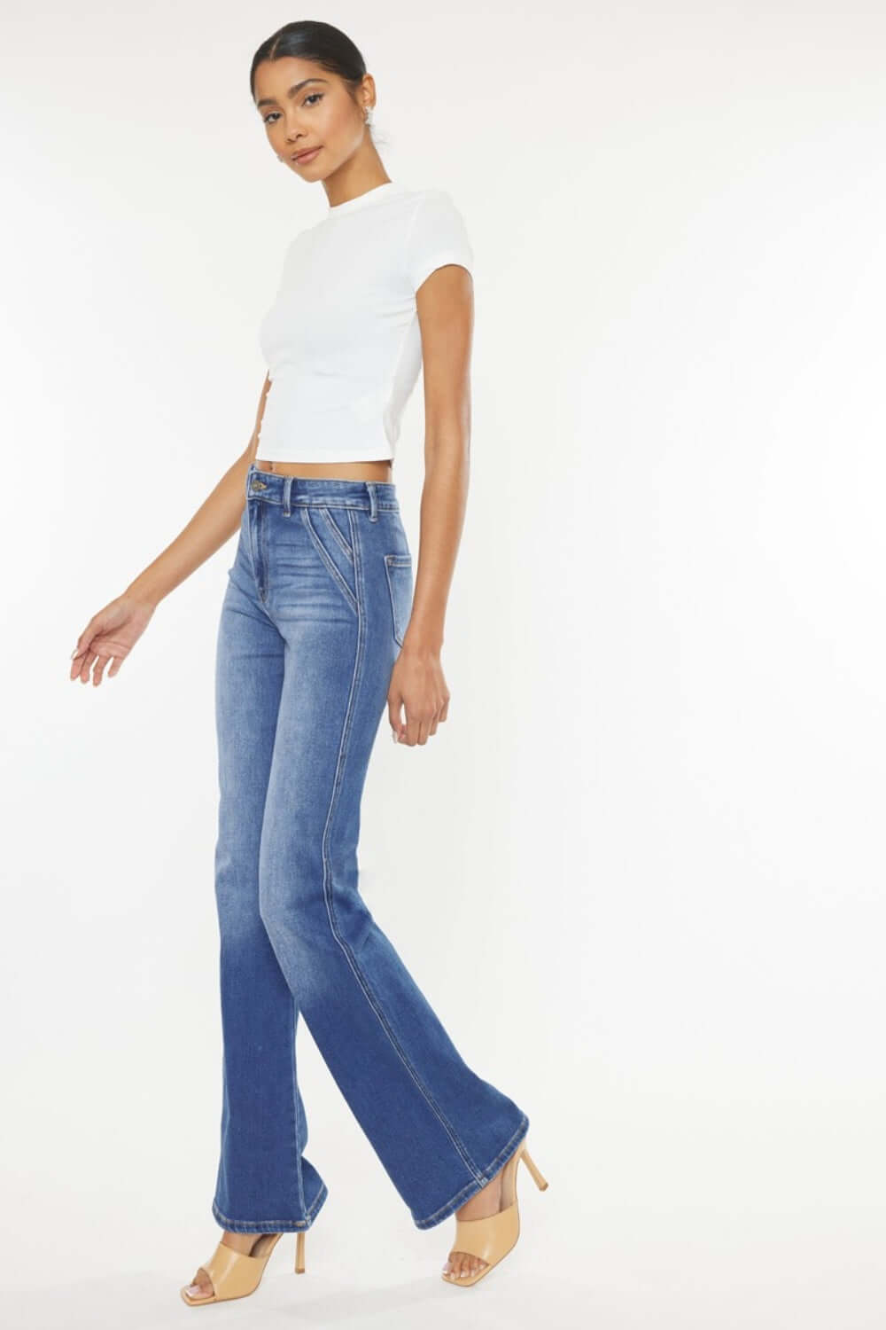 Model wearing Ultra High Waist Gradient Flare Jeans with a chic white top and beige heels. Stylish and trendy denim look.