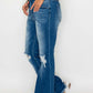 Woman wearing bytos Full Size Raw Hem Distressed High Rise Bootcut Jeans with a trendy and unique lived-in look.