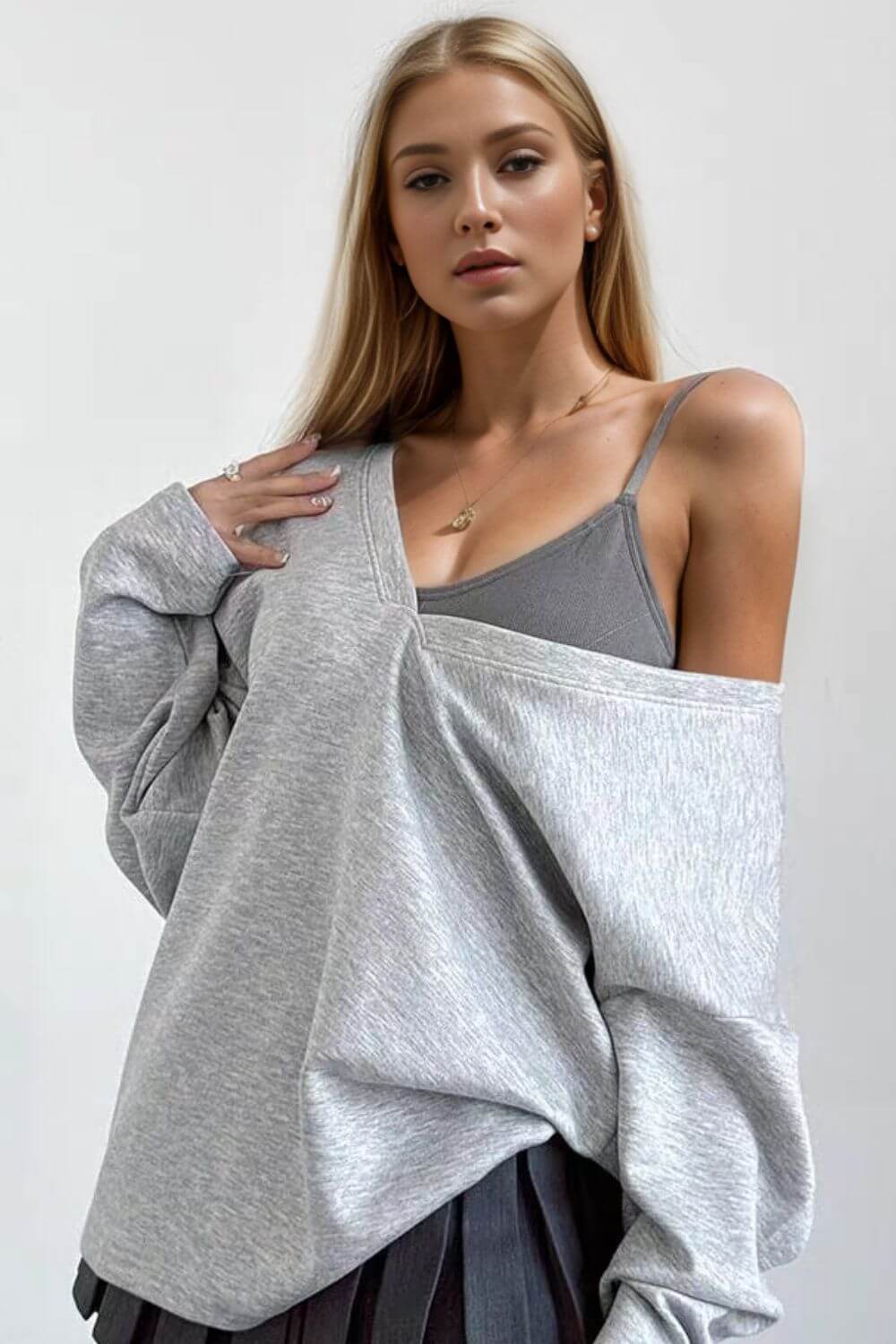 Woman wearing Basic Bae V-Neck Dropped Shoulder Long Sleeve Sweatshirt with built-in bra, showcasing casual comfort and style.