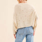 Woman wearing cozy Dolman Sleeves Sweater with a relaxed fit, shown from the back, paired with blue jeans. Perfect for cooler months.