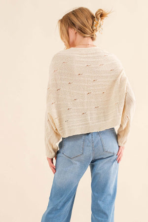 Woman wearing cozy Dolman Sleeves Sweater with a relaxed fit, shown from the back, paired with blue jeans. Perfect for cooler months.