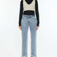 Woman wearing Raw Hem High Rise Straight Jeans for petite, with black turtleneck and beige crop sweater.