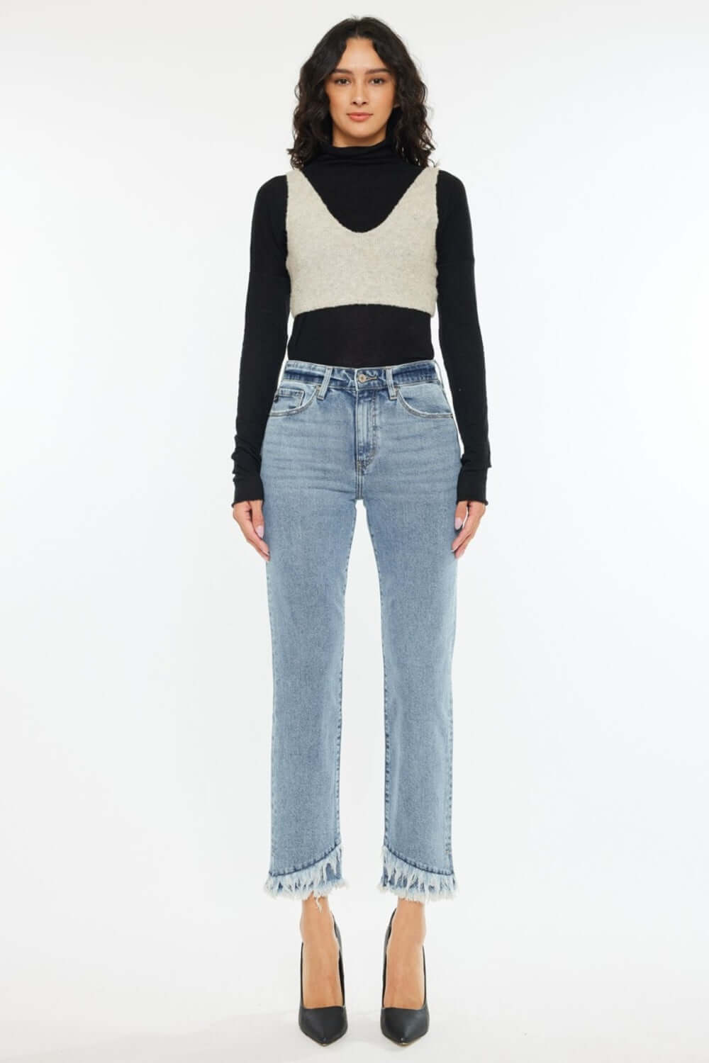 Woman wearing Raw Hem High Rise Straight Jeans for petite, with black turtleneck and beige crop sweater.